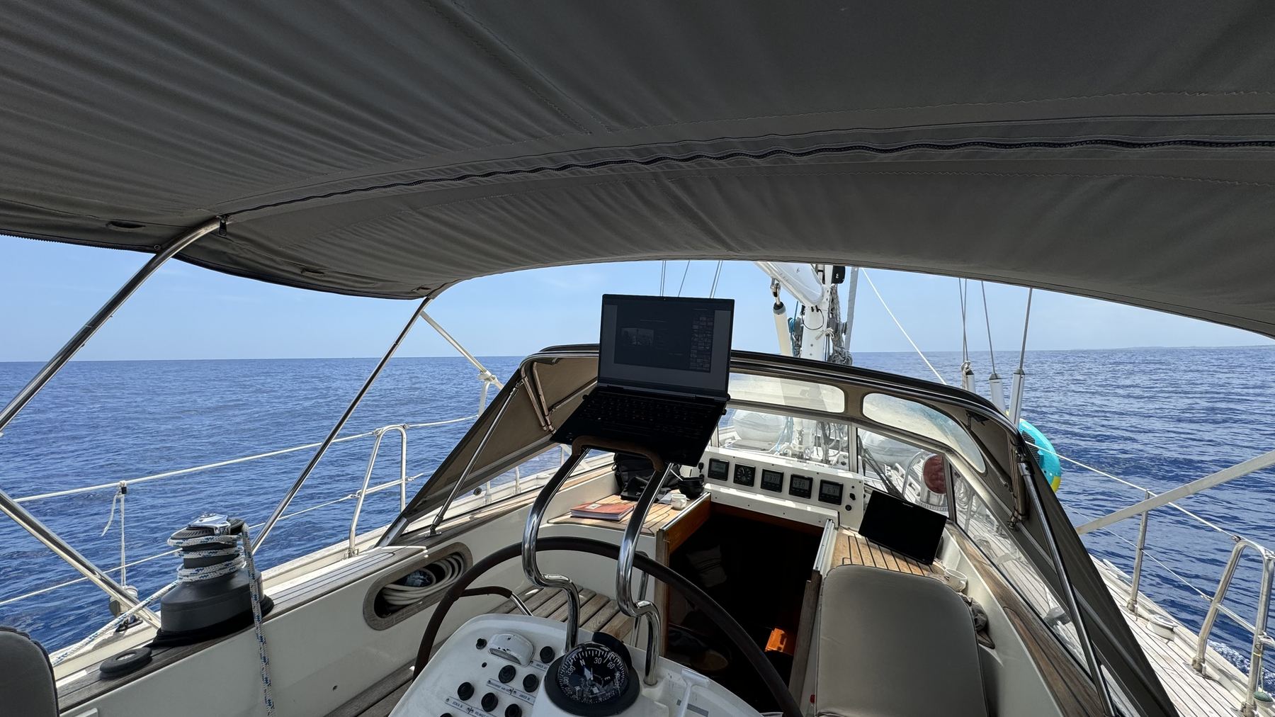 Laptop set up in the cockpit for a workation on the boat