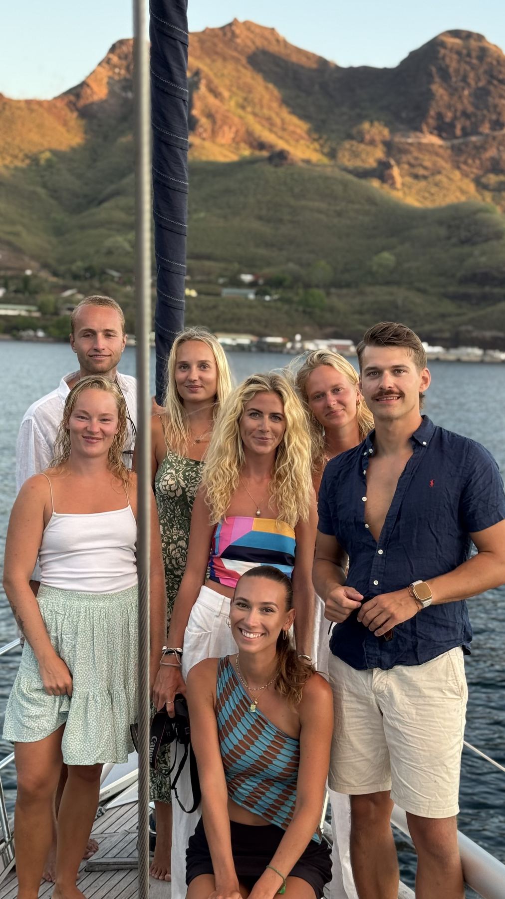 Group on deck with the mountains of French Polynesia behind