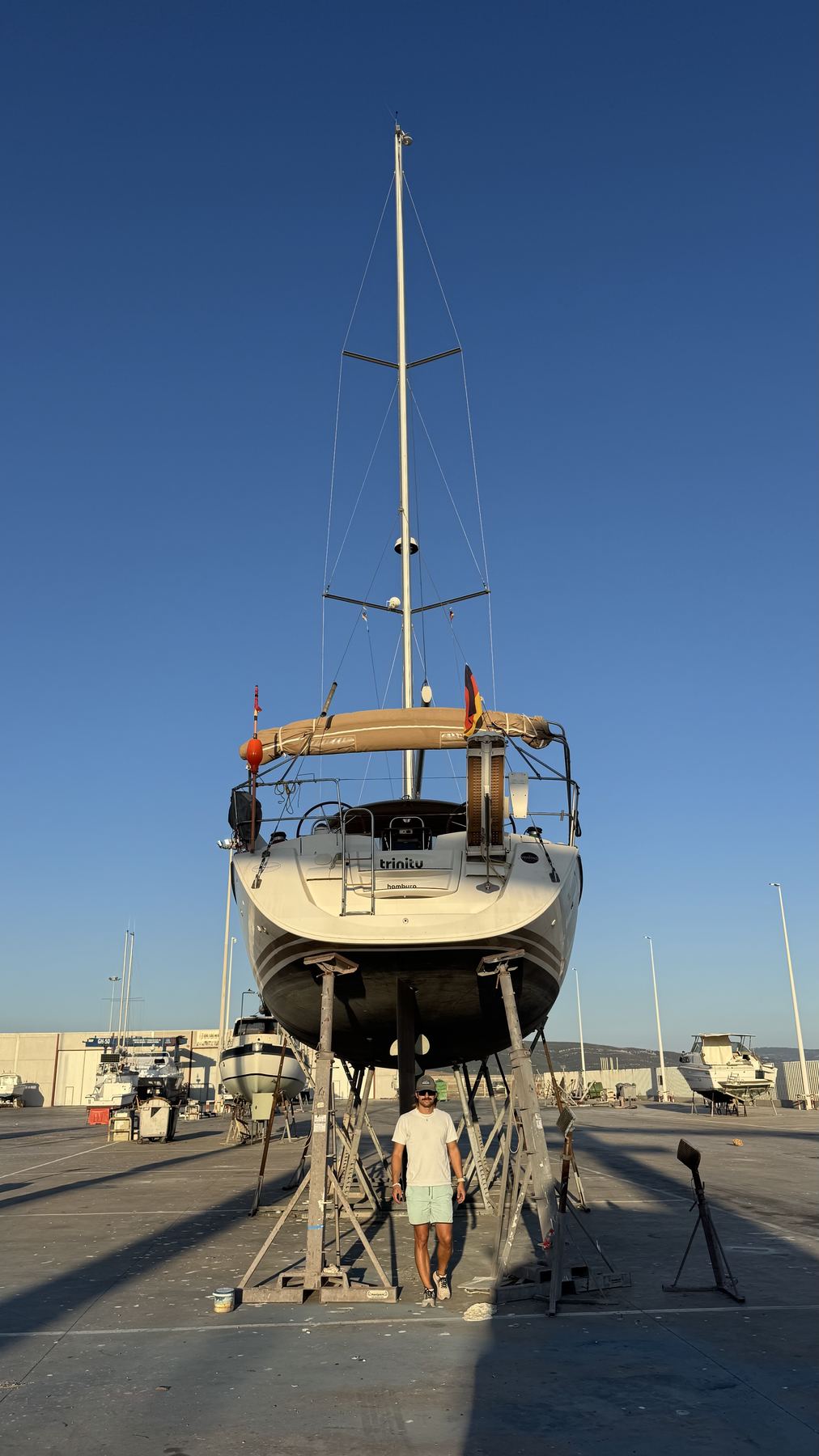Felix in front of the Trinity in the boatyard