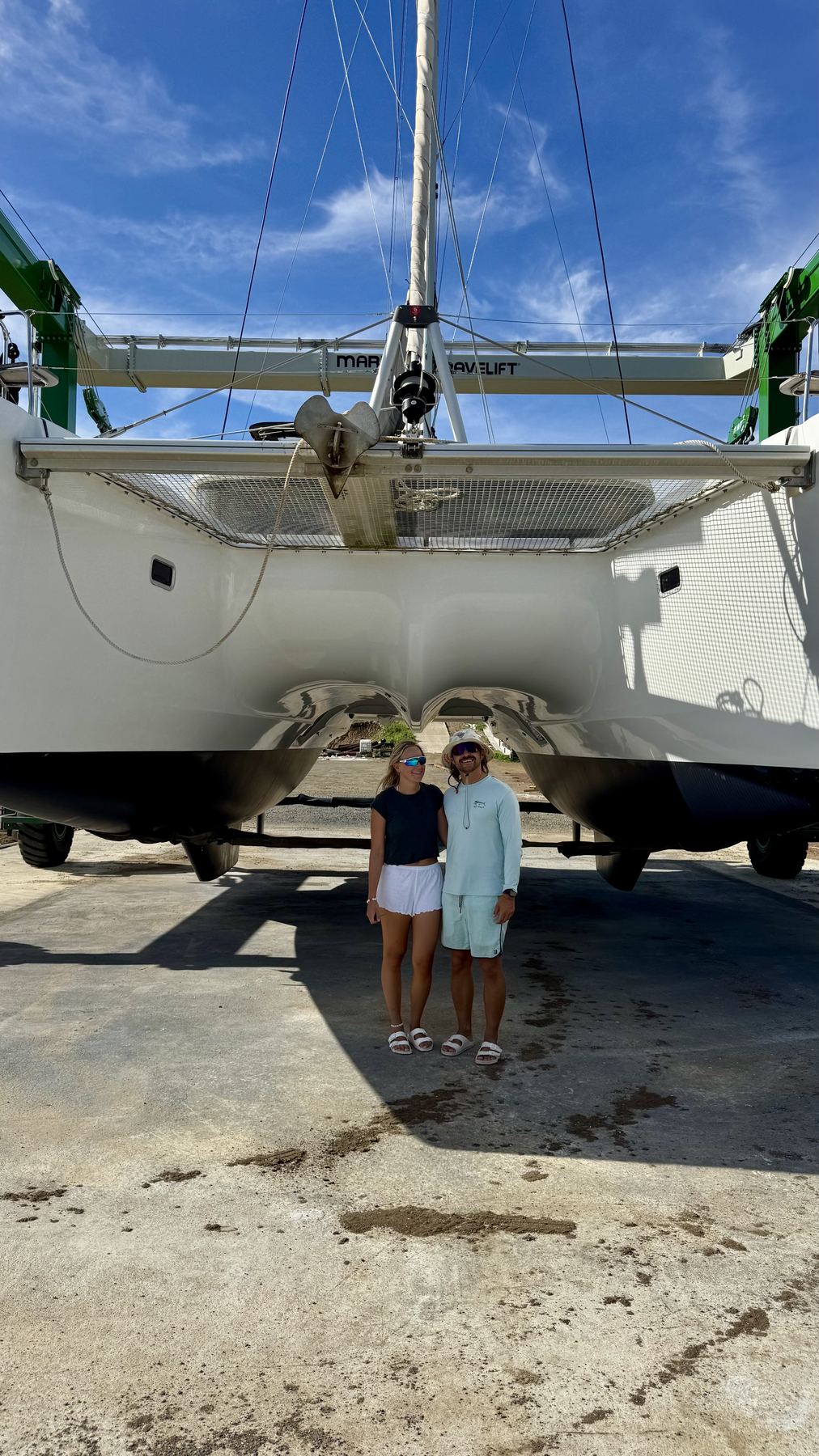 Felix and Ella standing under the hulls of Laurelli in Grenada